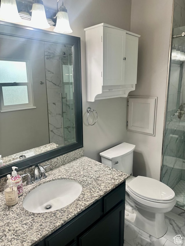 full bath with marble finish floor, toilet, vanity, and a marble finish shower