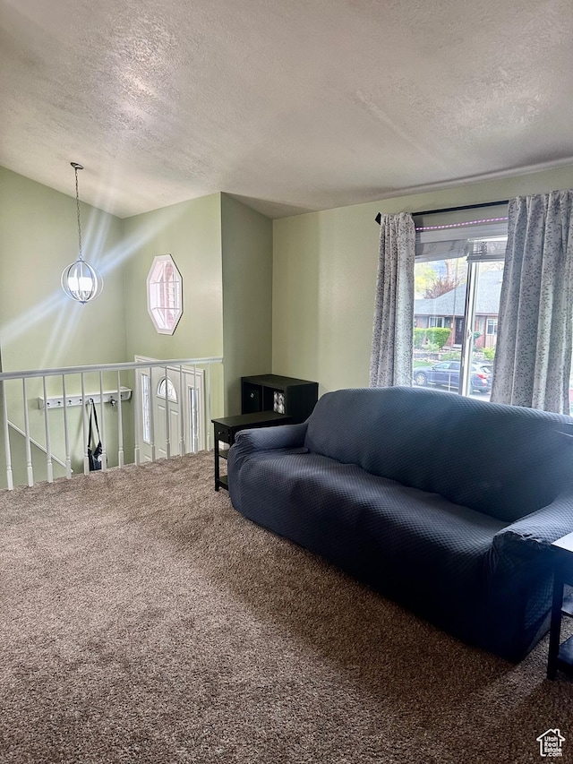 carpeted living room with a textured ceiling