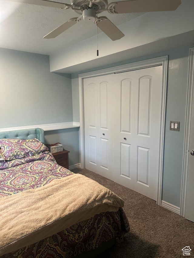 carpeted bedroom with a closet and ceiling fan