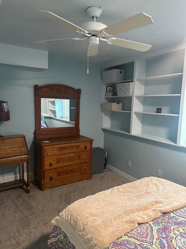 carpeted bedroom with baseboards, a ceiling fan, and a textured ceiling