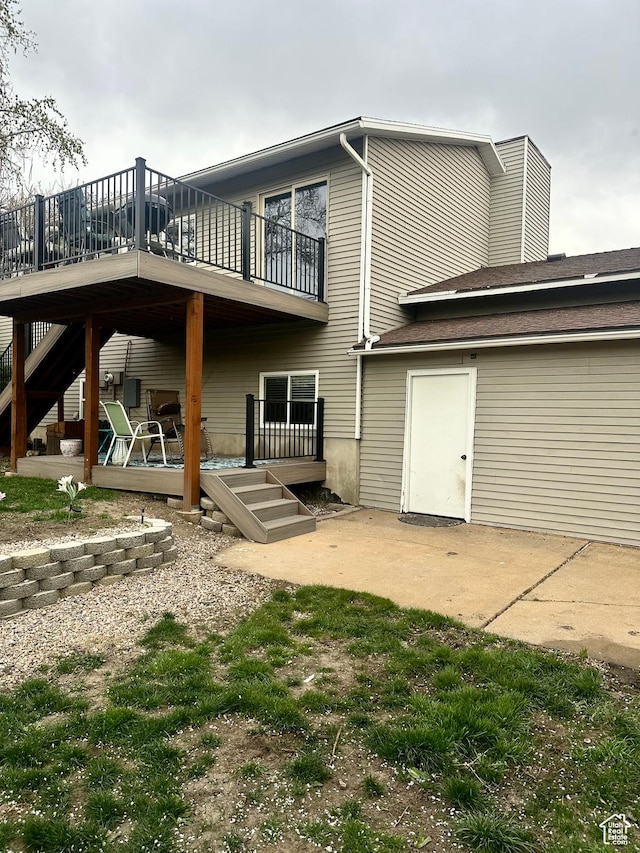 rear view of house featuring a deck and a patio