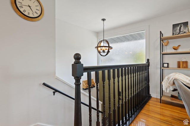interior space featuring wood finished floors and a chandelier