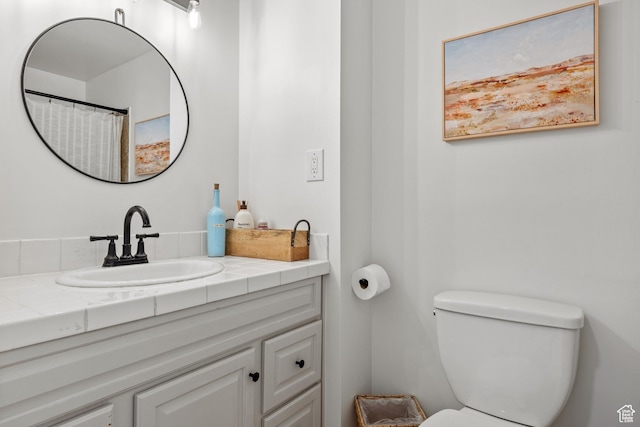 bathroom with toilet and vanity