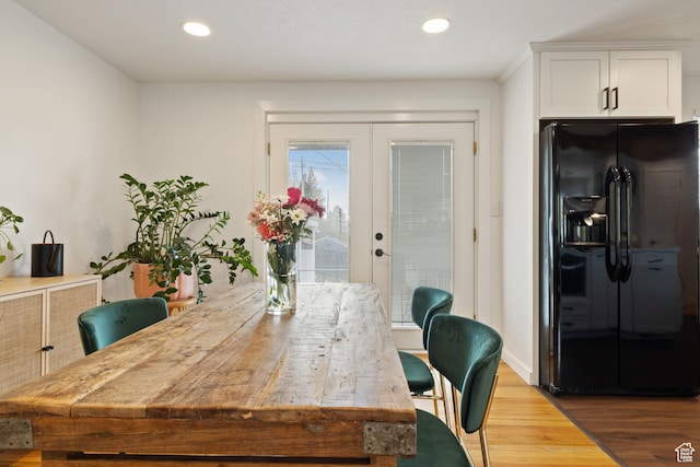 dining room with recessed lighting, wood finished floors, and french doors