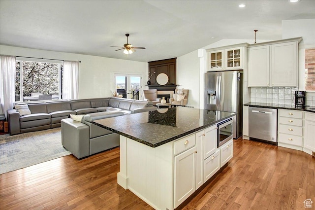 857 E Park School Rd, Draper, UT 84020 - kitchen with vaulted ceiling, wood finished floors, ceiling fan, stainless steel appliances, and backsplash