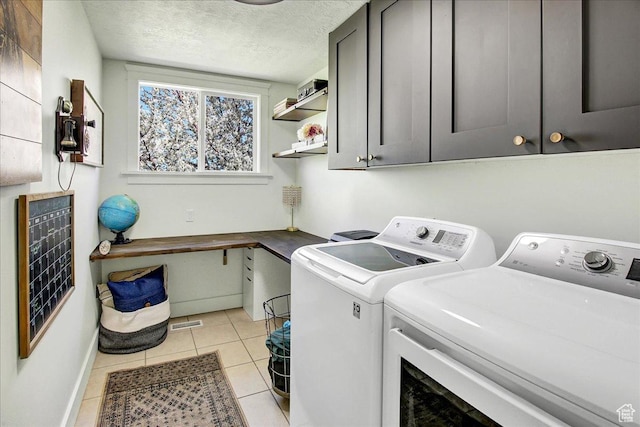 857 E Park School Rd, Draper, UT 84020 - clothes washing area featuring light tile patterned floors, washing machine and clothes dryer, baseboards, cabinet space, and a textured ceiling
