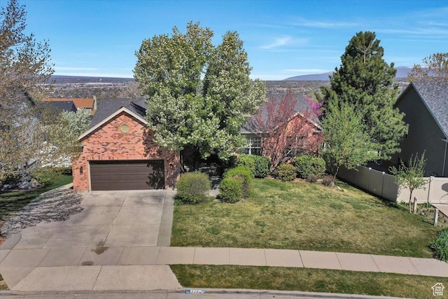 857 E Park School Rd, Draper, UT 84020 - obstructed view of property featuring fence, driveway, brick siding, a front yard, and a garage