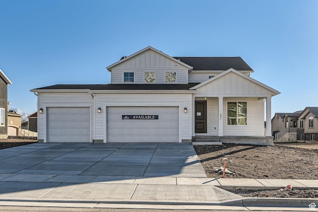 view of front of home with a porch, an attached garage, driveway, and board and batten siding