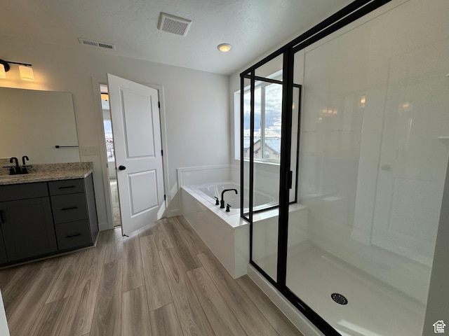 251 E Montgomery Ln, North Ogden, UT 84414 - bathroom with a bath, wood finished floors, visible vents, and vanity