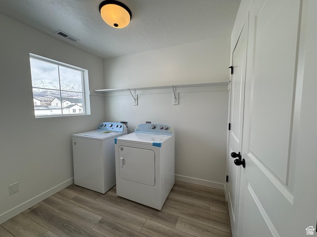 251 E Montgomery Ln, North Ogden, UT 84414 - laundry room with washing machine and clothes dryer, visible vents, laundry area, and light wood-type flooring
