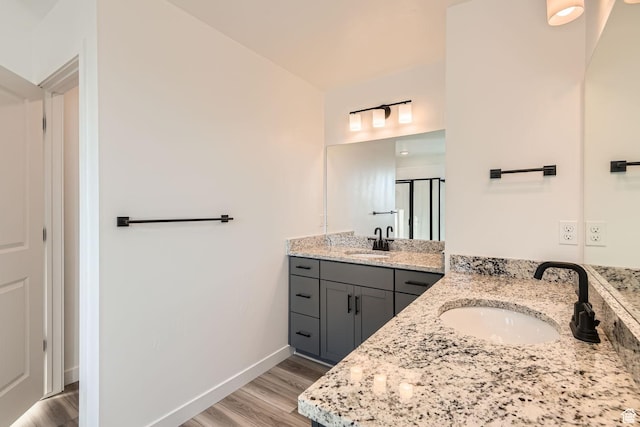 251 E Montgomery Ln, North Ogden, UT 84414 - full bathroom with two vanities, baseboards, wood finished floors, and a sink