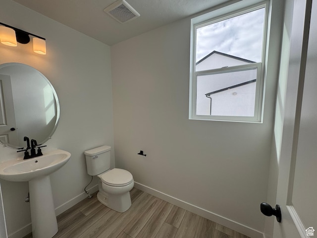 251 E Montgomery Ln, North Ogden, UT 84414 - half bathroom featuring baseboards, wood finished floors, visible vents, and toilet