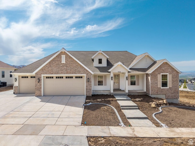 view of front of house featuring a porch, driveway, brick siding, and a garage
