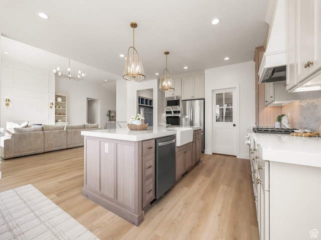 1554 S 920 E, Salem, UT 84653 - kitchen featuring custom exhaust hood, a notable chandelier, decorative backsplash, light countertops, and appliances with stainless steel finishes