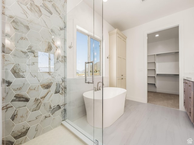 1554 S 920 E, Salem, UT 84653 - full bathroom featuring a walk in closet, a tile shower, a soaking tub, and recessed lighting