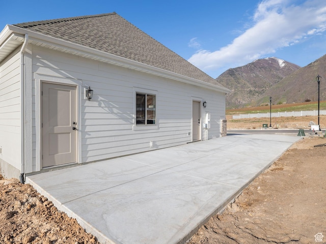 1554 S 920 E, Salem, UT 84653 - rear view of property featuring roof with shingles, a patio, and a mountain view