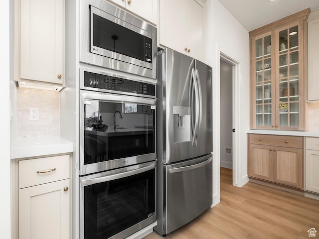 1554 S 920 E, Salem, UT 84653 - kitchen featuring decorative backsplash, stainless steel appliances, light countertops, and glass insert cabinets