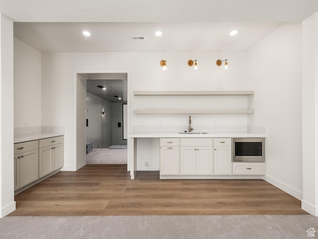 1554 S 920 E, Salem, UT 84653 - bar with a sink, stainless steel microwave, baseboards, light wood-style flooring, and indoor wet bar