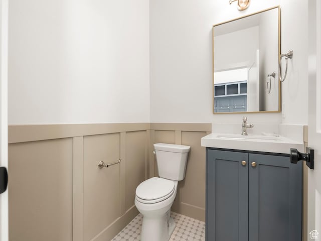 1554 S 920 E, Salem, UT 84653 - half bathroom with a decorative wall, toilet, vanity, and a wainscoted wall