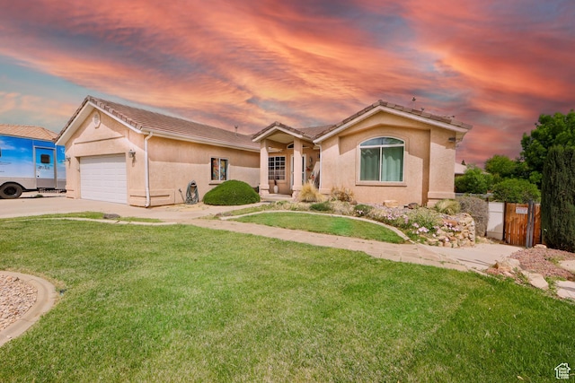 2201 S San Carlos Ct, Bloomington, UT 84790 - ranch-style house featuring a tiled roof, stucco siding, an attached garage, driveway, and a lawn