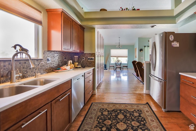 2201 S San Carlos Ct, Bloomington, UT 84790 - kitchen with light countertops, a sink, light wood-style floors, tasteful backsplash, and appliances with stainless steel finishes