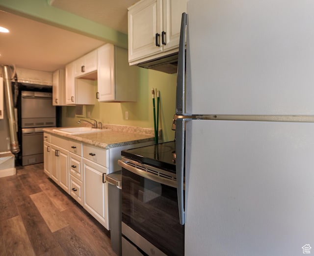 2201 S San Carlos Ct, Bloomington, UT 84790 - kitchen with a sink, dark wood-style flooring, freestanding refrigerator, white cabinetry, and light countertops
