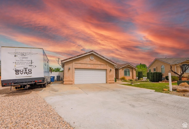 2201 S San Carlos Ct, Bloomington, UT 84790 - view of front of house featuring stucco siding, an attached garage, driveway, and a tile roof