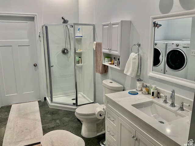 full bath with washing machine and dryer, vanity, a shower stall, and toilet