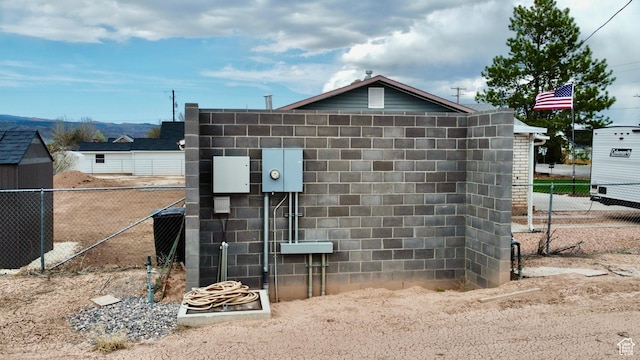 details featuring concrete block siding and fence