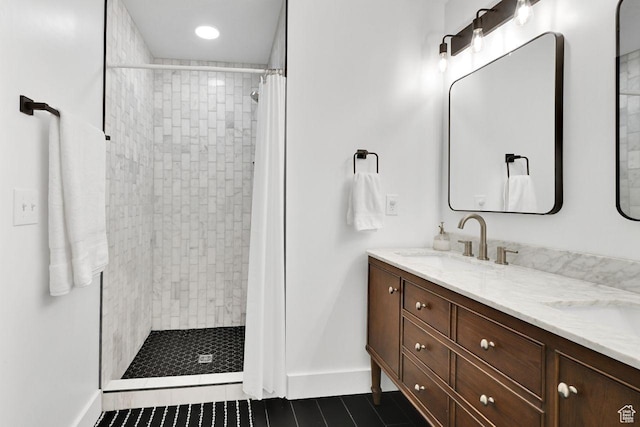 3708 S Luchars Ln W, Salt Lake City, UT 84115 - bathroom featuring a tile shower, double vanity, tile patterned flooring, and a sink