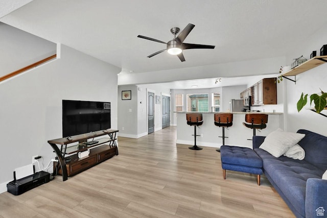 3708 S Luchars Ln W, Salt Lake City, UT 84115 - living area featuring light wood finished floors, baseboards, and ceiling fan