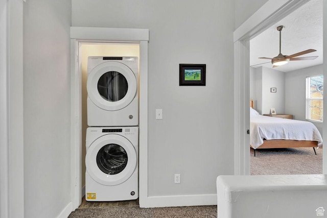 3708 S Luchars Ln W, Salt Lake City, UT 84115 - washroom featuring baseboards, a ceiling fan, stacked washer / dryer, and laundry area