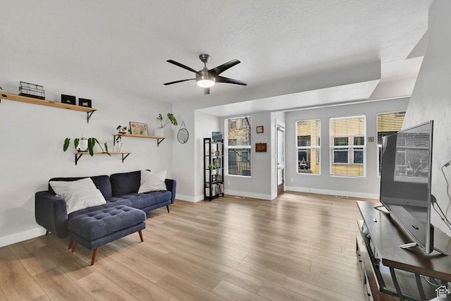 3708 S Luchars Ln W, Salt Lake City, UT 84115 - living area featuring light wood-type flooring, baseboards, and ceiling fan