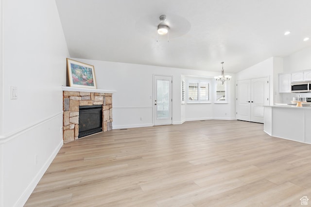 1354 S Star Cir W, Saratoga Springs, UT 84045 - unfurnished living room featuring baseboards, vaulted ceiling, light wood finished floors, and a fireplace
