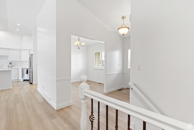 1354 S Star Cir W, Saratoga Springs, UT 84045 - hall featuring visible vents, an upstairs landing, light wood-style floors, high vaulted ceiling, and a notable chandelier