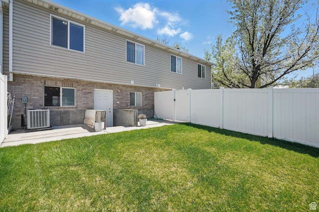 314 E 1000 N, Spanish Fork, UT 84660 - rear view of house with a lawn, fence, cooling unit, and brick siding