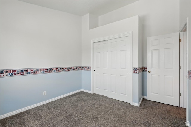 314 E 1000 N, Spanish Fork, UT 84660 - unfurnished bedroom with dark colored carpet, a closet, and baseboards