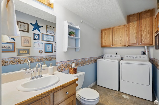 314 E 1000 N, Spanish Fork, UT 84660 - bathroom with washing machine and clothes dryer, a textured ceiling, vanity, toilet, and tile patterned flooring