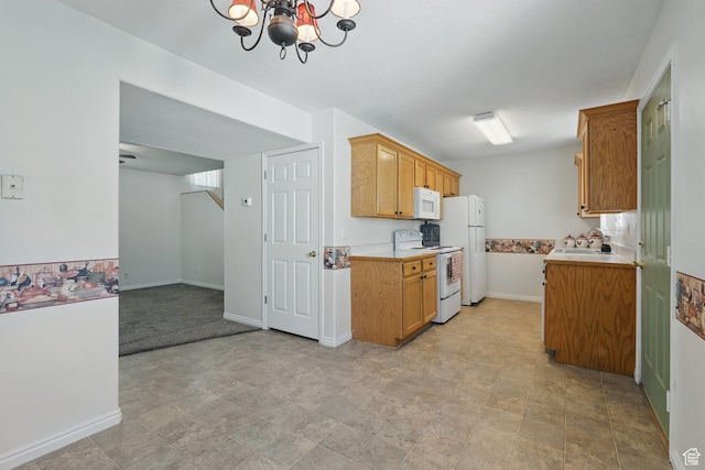 314 E 1000 N, Spanish Fork, UT 84660 - kitchen with a sink, baseboards, a notable chandelier, white appliances, and light countertops