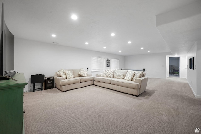living room featuring recessed lighting, baseboards, and light colored carpet