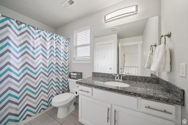 bathroom featuring tile patterned flooring, vanity, toilet, a shower with shower curtain, and visible vents