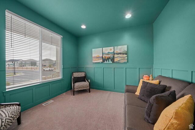 sitting room with visible vents, a wainscoted wall, light carpet, a decorative wall, and recessed lighting
