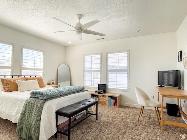 bedroom with a ceiling fan, a textured ceiling, carpet, baseboards, and visible vents
