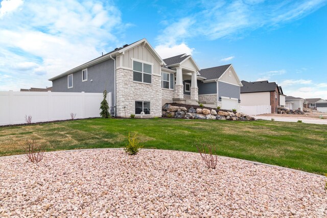 3698 S 5325 W, Hooper, UT 84315 - rear view of property featuring a lawn, fence, stone siding, and board and batten siding