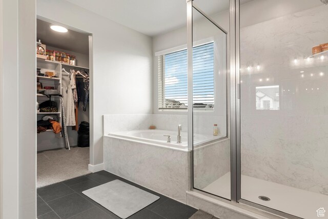 3698 S 5325 W, Hooper, UT 84315 - bathroom with a walk in closet, a shower stall, a garden tub, and tile patterned floors