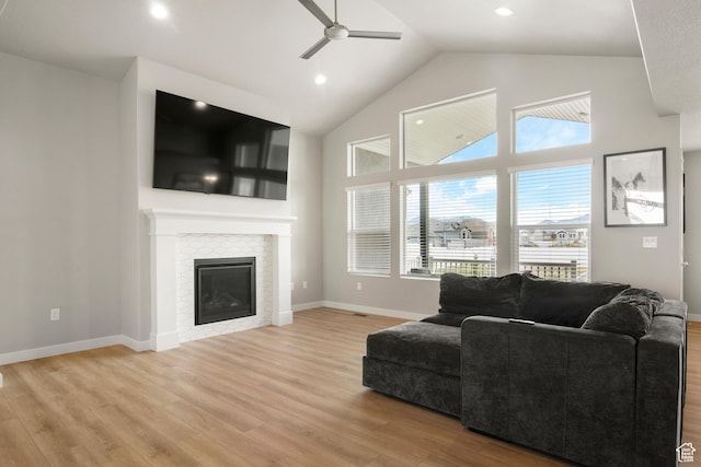 3698 S 5325 W, Hooper, UT 84315 - living room featuring a tile fireplace, high vaulted ceiling, light wood-style floors, and ceiling fan