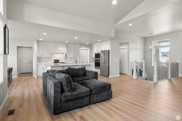3698 S 5325 W, Hooper, UT 84315 - living room with vaulted ceiling, light wood finished floors, baseboards, visible vents, and recessed lighting