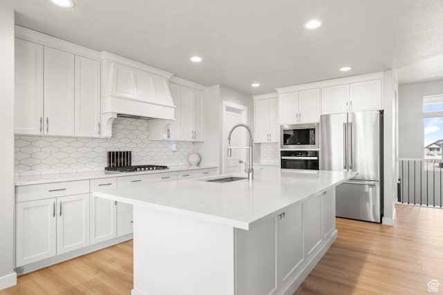 3698 S 5325 W, Hooper, UT 84315 - kitchen with light wood-style flooring, a sink, a center island with sink, white cabinetry, and appliances with stainless steel finishes