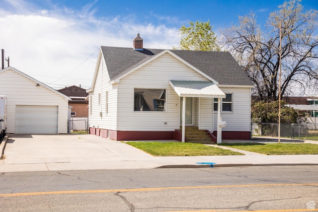 418 E 100 N, Vernal, UT 84078 - view of front facade featuring a detached garage, concrete driveway, fence, an outbuilding, and roof with shingles