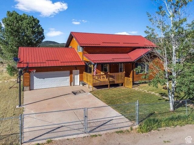 770 W Carter Dr, Pine Valley, UT 84781 - chalet / cabin featuring a front lawn, a fenced front yard, driveway, a porch, and an attached garage